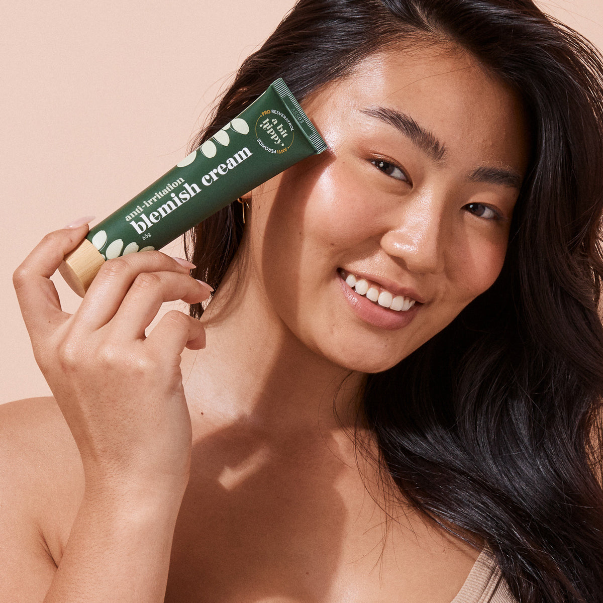Model showing A bit Hippy blemish cream, natural skincare for spots and acne