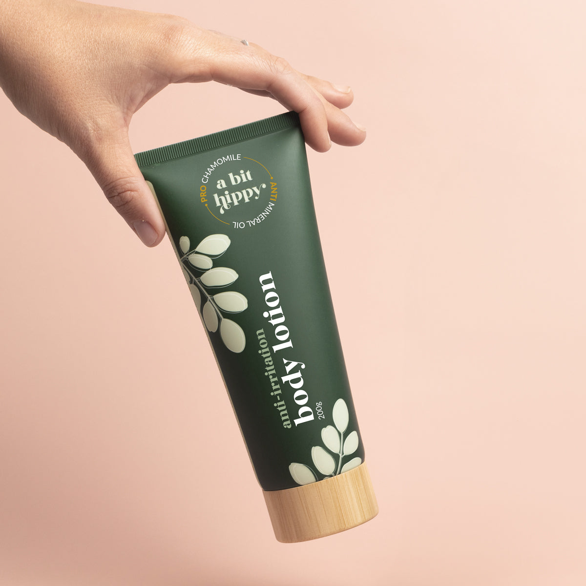Eco tube of A bit Hippy Body Lotion 200g held in hand, soothing and hydrating natural body care