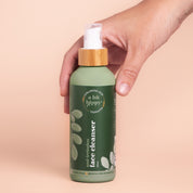 Hand holding A bit Hippy Face Cleanser 200ml bottle on peach background, Sulphate and SLS free cleanser with Hyaluronic Acid and Ceramides.