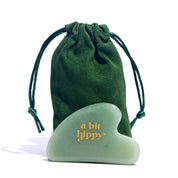 A bit Hippy Jade Gua Sha tool and bag on white background, promotes circulation for the perfect skin routine.