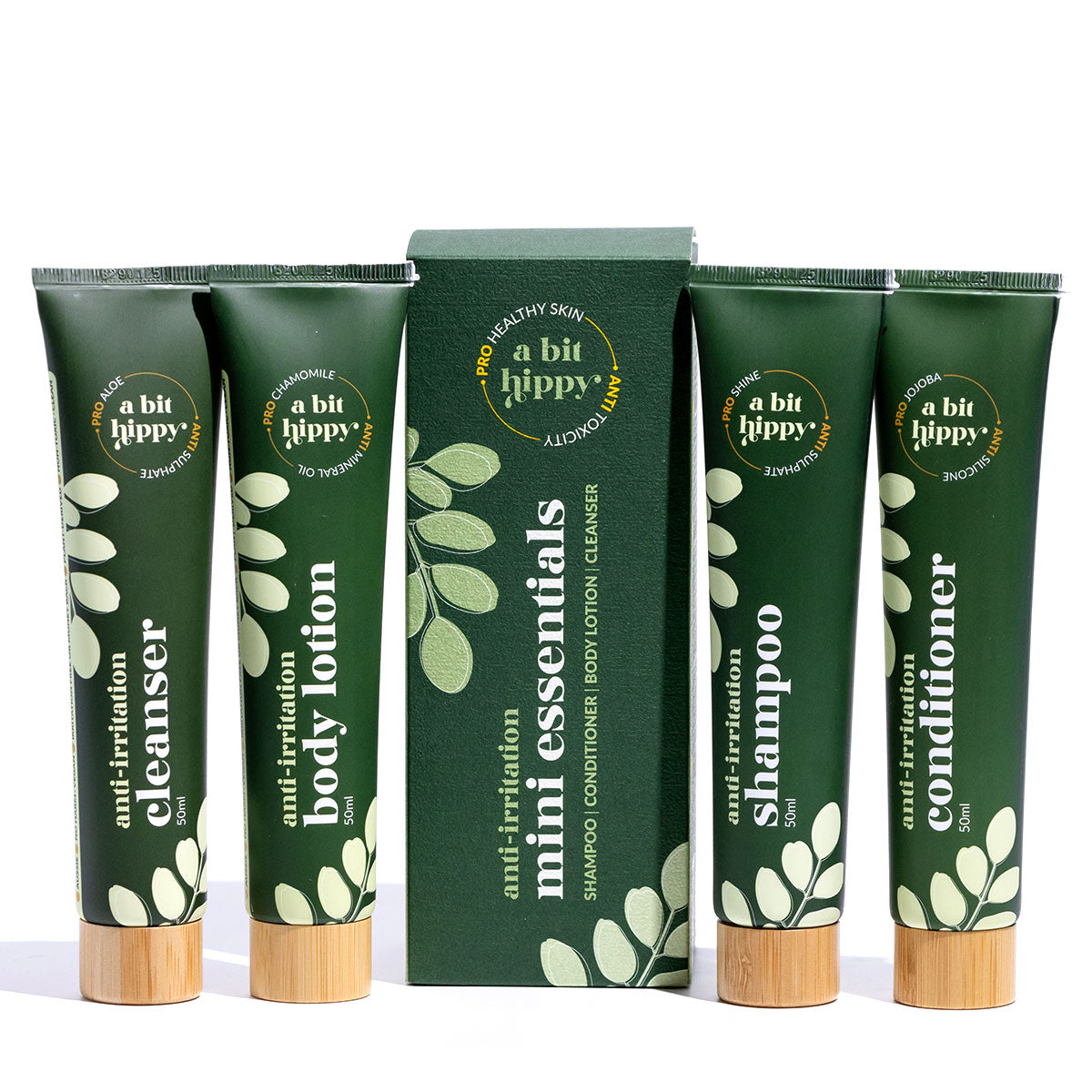A bit Hippy Mini Essentials Pack on white background, containing 50ml Shampoo, Conditioner, Body Lotion and cleanser. 