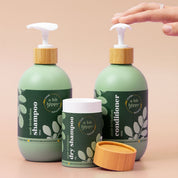 A bit Hippy Hair Bundle containing Shampoo 500ml, Conditioner 500ml and Dry Shampoo on peach background, Silicones and SLS free hair care kit for healthy and shiny hair.