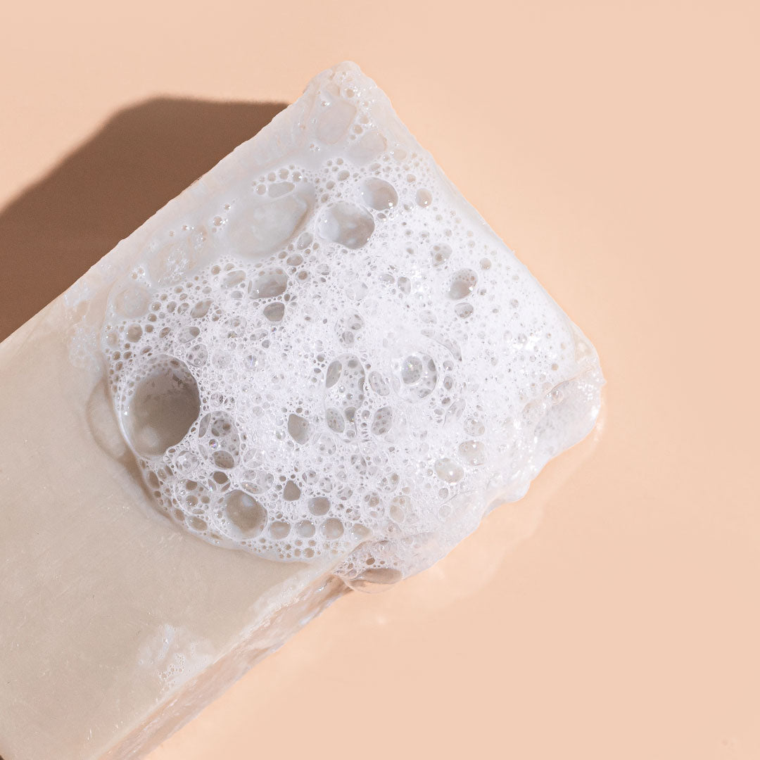 A bit Hippy Cleansing Hemp & Olive Body Bar 115g covered in bubbles, natural Australian-made soap with hemp seed oil and olive clay for hydrating and purifying skin