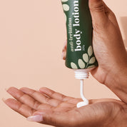 A bit Hippy Body Lotion squeezed into hand from green bamboo-cap tube, lightweight cream texture for daily hydration