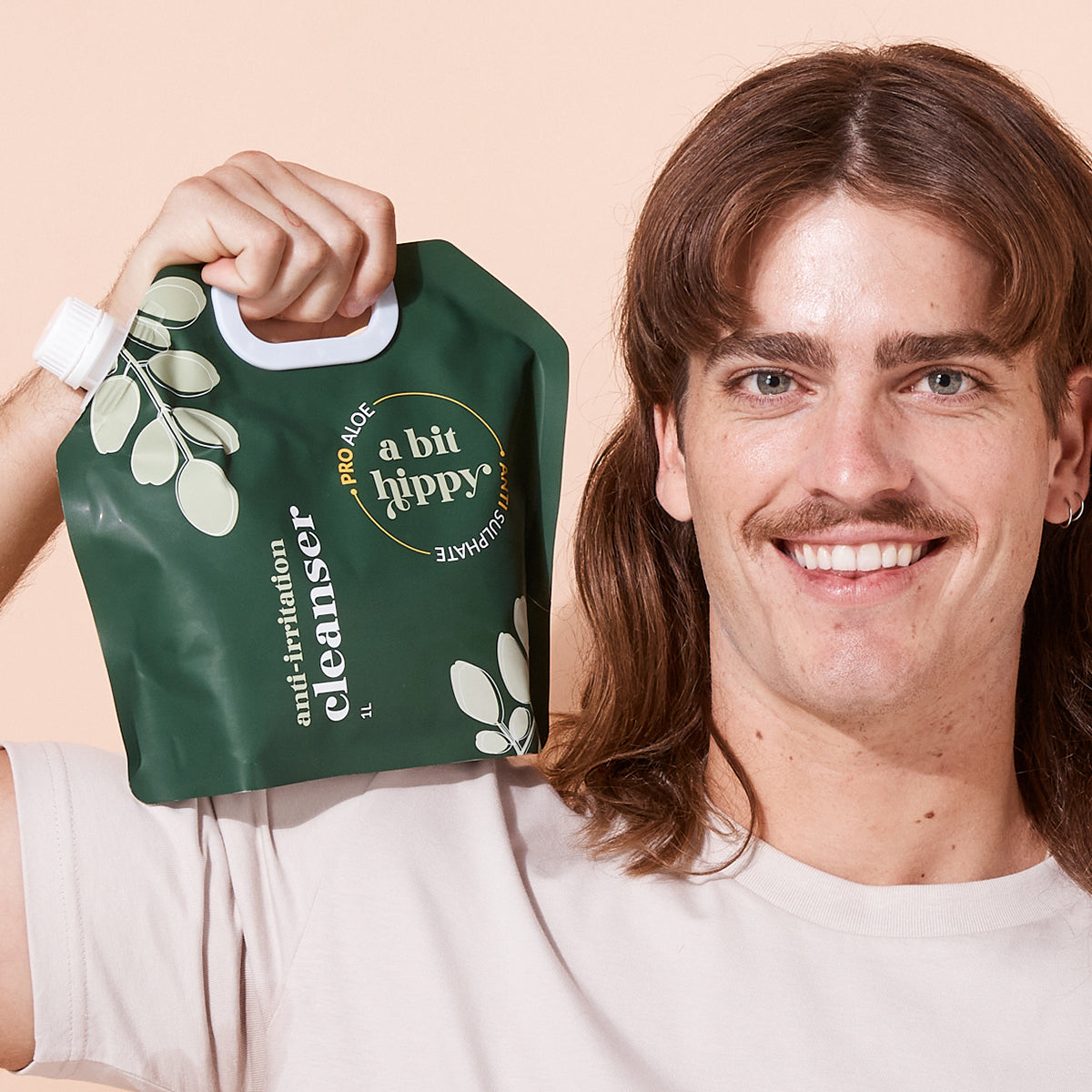 Man holding A bit Hippy cleanser 1L refill pouch, natural sulphate-free wash for sensitive skin