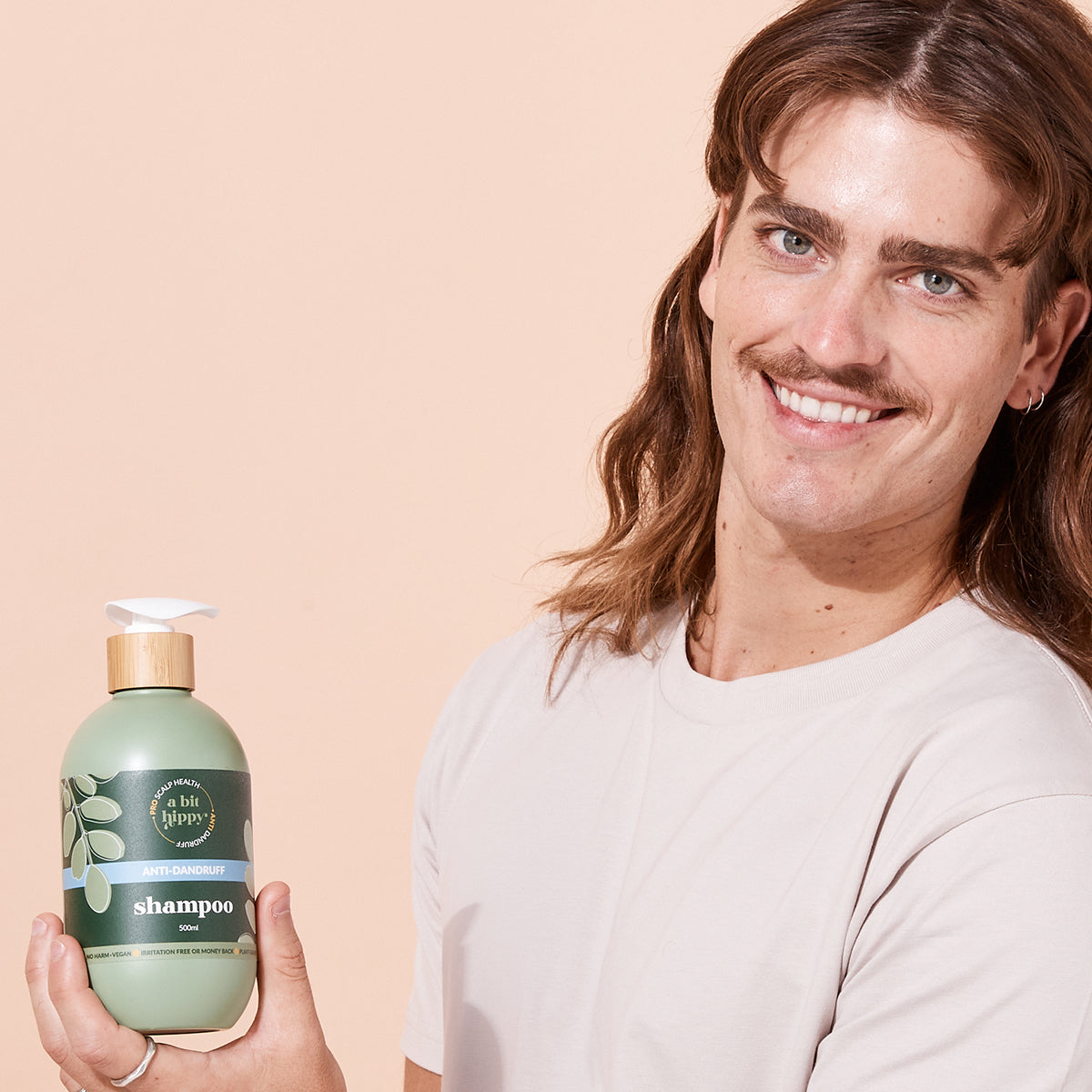 A bit Hippy Anti-Dandruff Shampoo lifestyle photo with man, gentle plant-based formula for dandruff relief