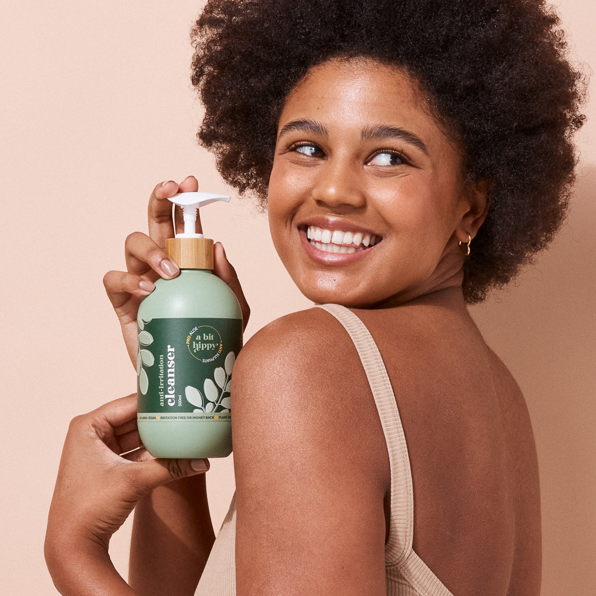 Model showcasing A bit Hippy Cleanser 500ml bottle, gentle aloe infused wash for sensitive skin, natural and irritation free